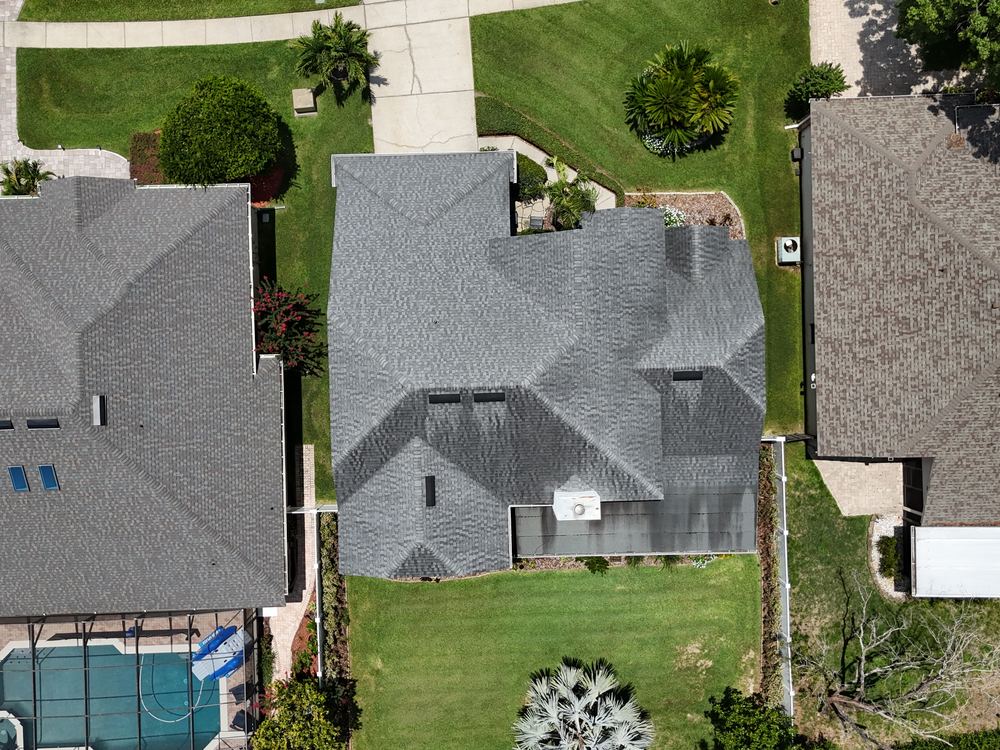 Overhead aerial of a newly installed grey architectural shingle roof by AlphaCore Roofing