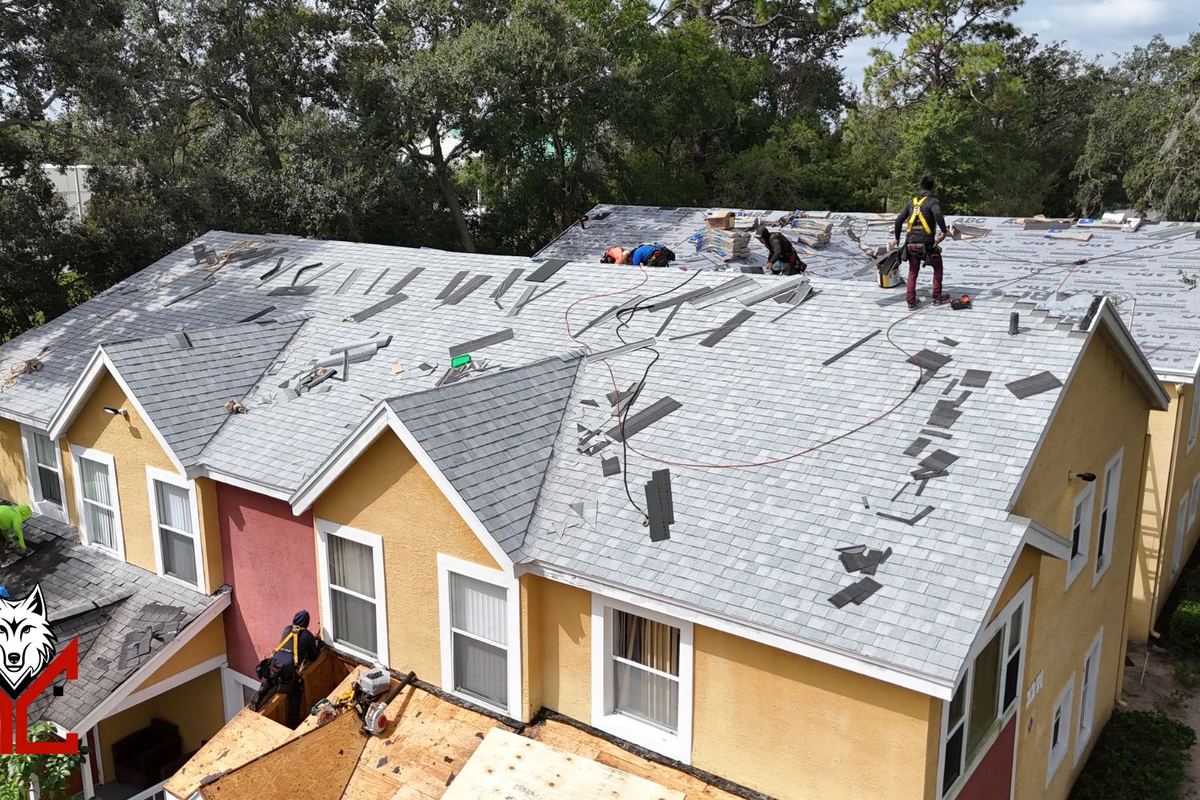 AlphaCore crew member standing on a Central Florida roof during an inspection