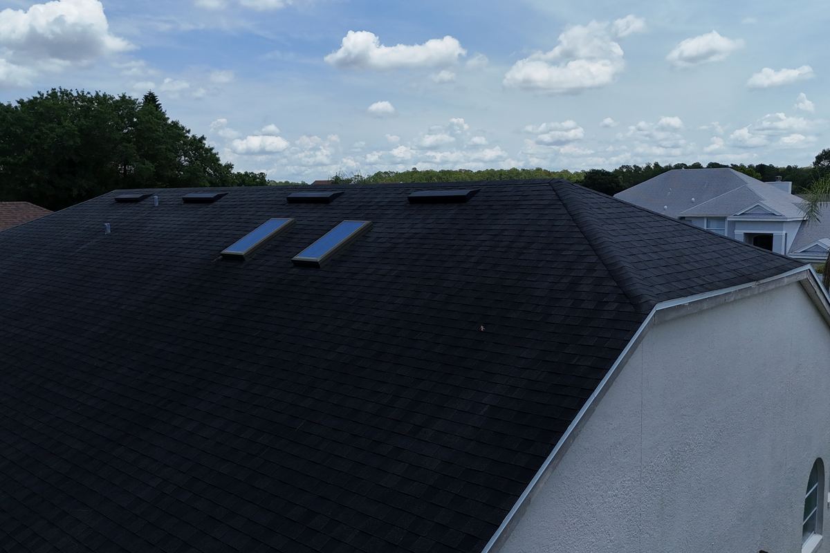 Close aerial of an asphalt shingle roof plane repaired by AlphaCore Roofing