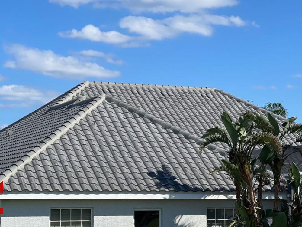 Finished concrete tile roof against a blue Florida sky installed by AlphaCore Roofing